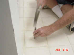 Breaking the center of the tile for easy�removal