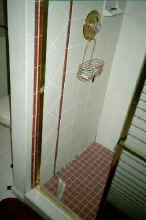 shower before - missing grout caused wall damage behind the tile